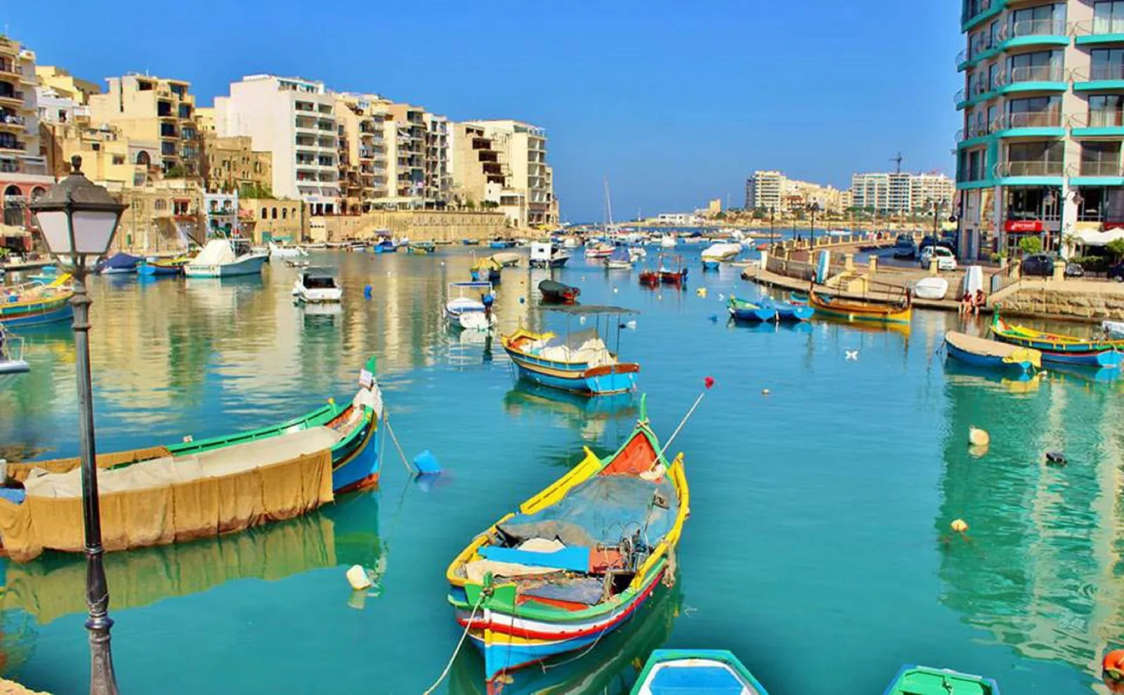 Traditional fishing boats in Spinola Bay during a language stay in St Julian's, Malta
